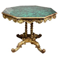 an ornately decorated table with green marble top