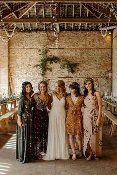 a group of women standing next to each other in front of a wall with lights