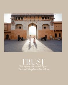 two women are standing in front of an archway with the words trust on it,