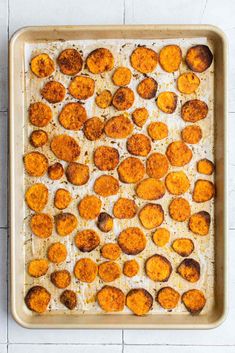 baked sweet potatoes on a baking sheet ready to go into the oven for roasting