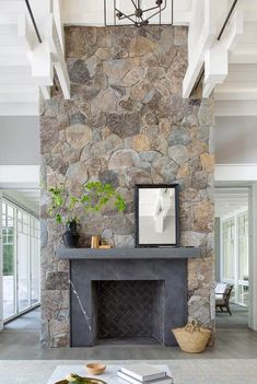 a stone fireplace with a mirror on top