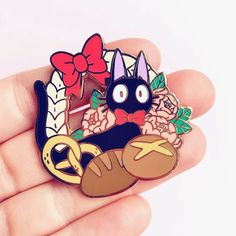 Carry a piece of Ghibli magic with you wherever you go with this Kiki’s Delivery Service Enamel Pin. Nestled inside a delightful bread wreath, this adorable pin captures the charm of Kiki's loyal companion. With its glossy finish, it gleams and shimmers in the light. Crafted with durable material it ensures that Jiji will accompany you on countless adventures. The back features a secure butterfly clutch, allowing you to clip it confidently to your backpack, jacket, or tote bag. Size: 2.7 cm x 2. Enamel Pin Collection, Cat Enamel Pin, Jacket Pins, Bag Pins, Kiki's Delivery Service, Enamel Badges, Pretty Pins, Enamel Lapel Pin, Cool Pins