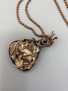 Triangular shaped stone with coppers, gold, beige, and pinks -- looks like an abstract painting! Stone is wire wrapped in oxidized copper to make it antique-looking. The design has a pretty rosette at the base of the bail. Pendant is 2 inches tall and 1.5 inches wide and comes with a free chain. Petrified Wood Jewelry, Oxidized Copper, Wood Jewelry, Petrified Wood, Wrapped Pendant, Wire Wrapped Pendant, Antique Copper, Copper Wire, Wire Wrapping