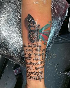 a woman's leg with a butterfly tattoo on it and words written in different languages