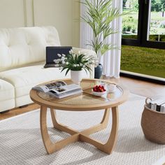 a living room with a white couch and coffee table in front of a sliding glass door