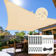 an outdoor patio with table and chairs under a large shade sail over the dining area