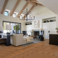 a living room filled with furniture and a fire place in the middle of a room