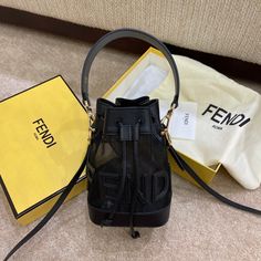 Mini Mon Tresor bucket bag made of black mesh and featuring Fendi lettering and a tone on tone leather trim.Lined and with gold-finish metalware.Two detachable shoulder straps, one long and one short, to wear the bag over the shoulder or cross-body.Made in Italy RODUCT INFORMATION Length:12, cm Height:18, cm Depth:10, cm Weight:0,275 kg Composition:100% Polyamide, 100% Calf leather Black Bucket Bag, Black Bucket, Diaper Backpack, Casual Backpack, Fendi Bags, Black Mesh, Bag Tags, Wallet Case, Bag Making