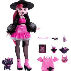 a doll dressed in pink and black with accessories including a batgirl outfit, purse, shoes, and hat