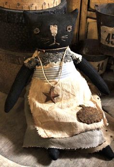 a black cat doll sitting on top of a table