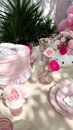 a table topped with lots of pink cakes and flowers