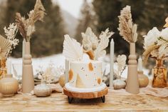 a table topped with a cake covered in frosting