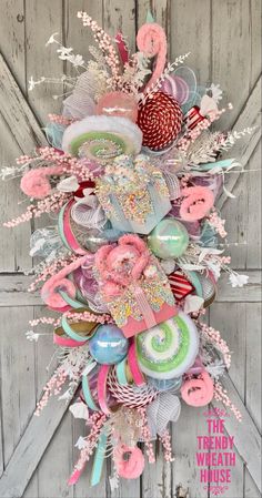 a wreath made out of donuts, candy and other items is hanging on the door