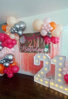 balloons and streamers decorate the entrance to a 21st birthday party