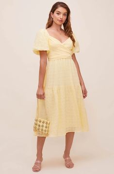 A dress that looks like a poem! The Sonnet Midi features a flattering V neckline that descends to a fitted bodice with a defined waist. Short puff sleeves and large bow accent at the back bring out the charm. Flowy midi-length skirt with a slightly ruffled trim. 100% Polyester Lining: 95% Polyester / 5% Elastane Self Tie Closure Dry Clean Only Puff Sleeve Midi Dress Back Tie Yellow Knee-length Midi Dress In Feminine Style, Feminine Yellow Knee-length Midi Dress, Feminine Yellow Midi Dress For Daywear, Yellow Dress With Sweetheart Neckline For Brunch, Feminine Yellow V-neck Midi Dress, Yellow Midi-length Dress With Fitted Bodice, Yellow Midi Dress With Fitted Bodice, Yellow Spring Dress With Sweetheart Neckline, Spring Yellow Dress With Sweetheart Neckline