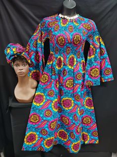 "Beautiful African print Dress with matching headwrap.  Colors dark pink, gold, blue ans black.  On/off shoulder Elastic Top to waist makes for nice fit for various sizes and figures. Long flare sleeves to wrist, ankle length with pockets. Perfect for all occasions. 100% cotton.  One size fits most (Medium to 2XL)  Measurements: Elastic top Bust 28\" - 48\" Sleeves length shoulder to waist 28\"- 44\" Hips- 54\" Length waist to hem 37\"" Fitted Long Sleeve Ankara Maxi Dress, Blue Long Sleeve Ankara Dress, Long Sleeve Ankara Fabric Spring Dress, Spring Ankara Long Sleeve Dress, Spring Long Sleeve Ankara Dress, High Wasted Pants, Womens Jumpsuits, Elastic Top, Flare Sleeves