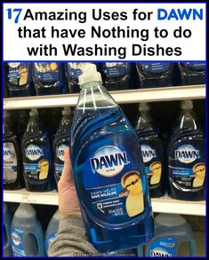 a hand holding a bottle of dawn dishwasher detergent in front of shelves