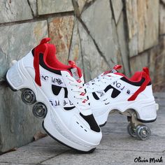 a pair of white and red sneakers on roller skates next to a stone wall