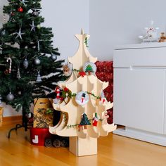 a small wooden christmas tree with ornaments on it