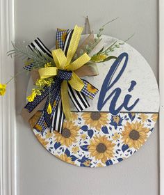 a sunflower wreath is hanging on the front door to give it a personalized name