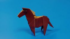 an origami horse on a blue background