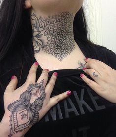 a woman with tattoos on her neck and hands