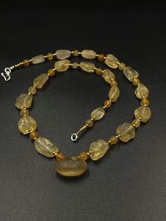 A beautiful collection of ancient crystal quartz Beads necklace From India from ancient times . They appear broken but its natural shaped that they were found in. They are beautiful shaped natural design. some brass beads are used as spacers in the necklace They were used in prayer mala and used in necklaces in ancient times we provide fast and free shipping service world wide Luxury Spiritual Oval Beads Jewelry, Gold Hand-strung Beads And Cabochons, Artisan Faceted Gold Beads, Artisan Gold Faceted Beads, Amber Beaded Crystal Necklace With Round Beads, Amber Beaded Crystal Necklace, Gold Artisan Beaded Necklaces With Faceted Beads, Artisan Gold Beaded Necklace With Faceted Beads, Artisan Gold Beaded Necklaces With Faceted Beads