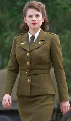 a woman in an army uniform is walking