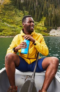 a man sitting in a boat holding a water bottle