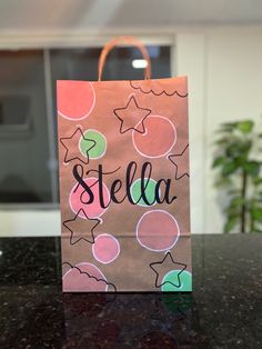 a brown paper bag with the word stella on it