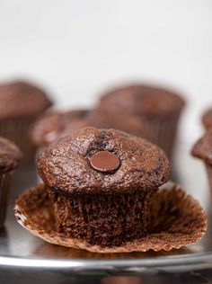 chocolate cupcakes sitting on top of a metal plate