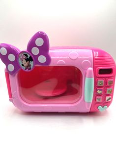 a pink minnie mouse microwave oven with polka dots on it