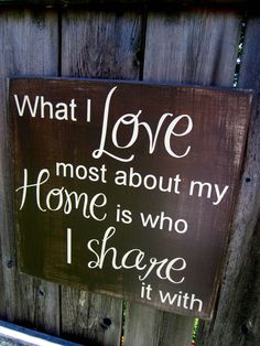 a wooden sign that says what i love most about my home is who i share it with