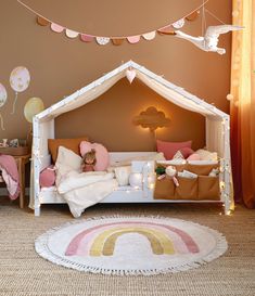 a child's bedroom with a bed and rug