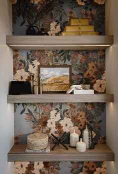 the shelves are decorated with flowers and books on them, along with other decor items