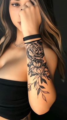 a woman with a rose tattoo on her arm holding her hand up to her face