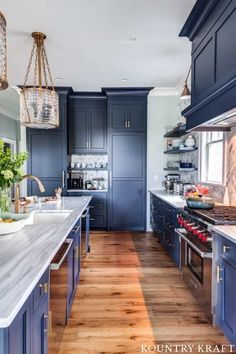 a kitchen with blue cabinets and wooden floors