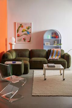 a living room filled with furniture next to a wall mounted book shelf and a painting on the wall