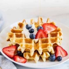 a waffle topped with strawberries and blueberries