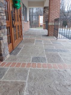 a dog is standing on the front porch