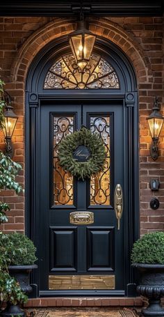 a black front door with a wreath on it