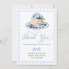 a blue and white checkered card with a cake on it