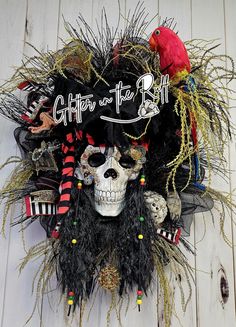 a skull wearing a pirate hat with feathers on it's head and the words coffee at the bottom