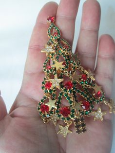 Beautiful vintage unsigned Kirks Folly Limited Edition Christmas Tree Brooch with dangle crystal gold plated star ornaments in excellent condition set in a gold plated setting and measures 4 inches long. Christmas Star-shaped Jewelry For Parties, Christmas Star-shaped Party Jewelry, Christmas Party Star-shaped Jewelry, Gold Holiday Brooch Jewelry, Gold Star Jewelry For Christmas, Christmas Bling, Star Ornaments, Cuyahoga Falls, Tacky Christmas