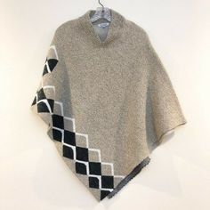 This adorable knit sweater from the brand Baciano is perfect for layering! It features a poncho style, easy for throwing over a long sleeve, and a somewhat higher neck in the back. Preloved but in excellent used condition! 100% acrylic. Women's size small (S). Length at longest point: 36 in One Size Vintage Poncho For Winter, Vintage Winter Poncho One Size, Vintage One-size Winter Poncho, Casual Wool Poncho One Size, Casual Wool Poncho, Casual One-size-fits-all Wool Poncho, Alpaca Poncho, Sweater Shawl, Acrylic Sweater