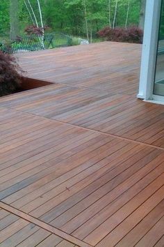 a wooden deck in front of a glass door