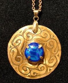 a necklace with a blue stone in the center