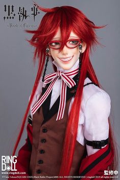 a doll with red hair and glasses on top of it's head is smiling