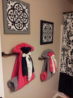 two towels are hanging on the wall in this bathroom