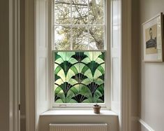 an image of a window with green leaves on it